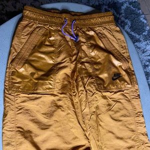 Copper colored pants size small with purple laces